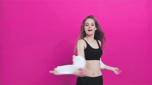 Young Woman Having Fun Smiling Dancing in Studio Shaking Her Hair While Listening to Music  alt
