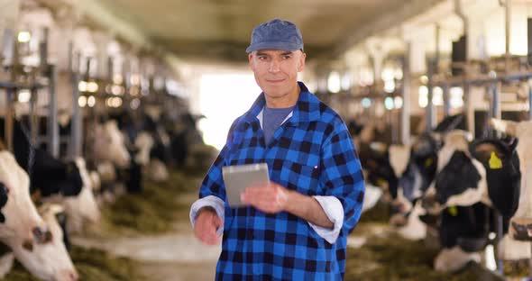 Thoughtful Mature Male Farmer Using Digital Tablet alt