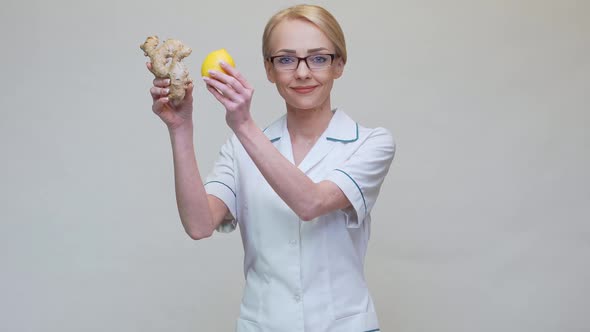 Nutritionist Doctor Healthy Lifestyle Concept - Holding Ginger Root and Lemon Fruit alt