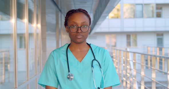Close Up Portrait of Afroamerican Female Healthcare Worker Standing Outside Hospital alt