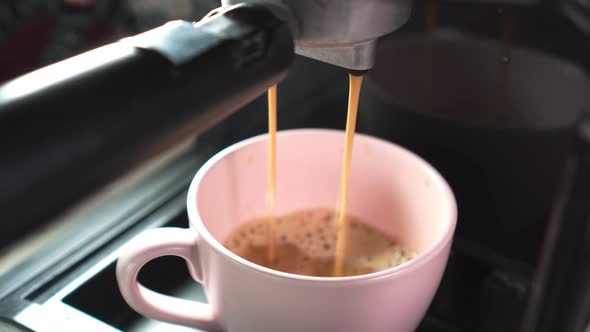 Footage B Roll of Pouring coffee stream from machine in cup. Home making hot Espresso.