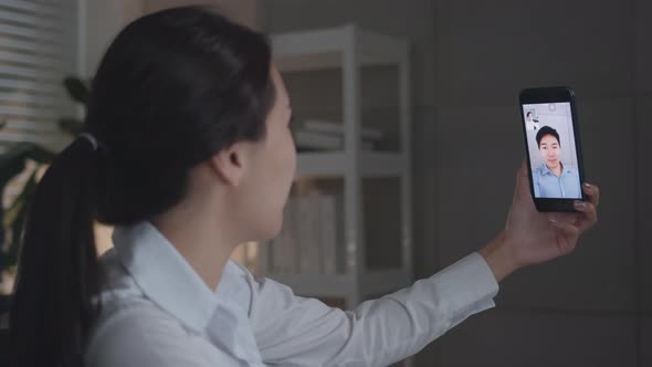 Attractive Businesswoman having video call with her manager, boyfriend on smartphone video chat, alt