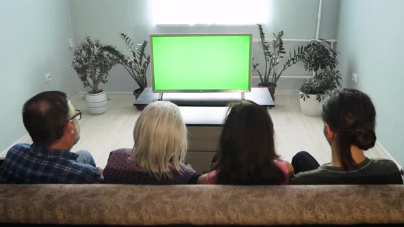 Family Watching TV. Green Screen. alt