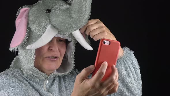 Closeup Shot of a Lady Showing Off an Elephant Costume on a Video Call