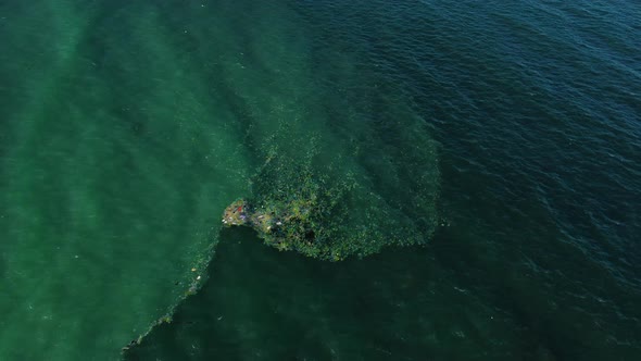 Plastic garbage is floating on the ocean waves near the Vietnam coastline alt