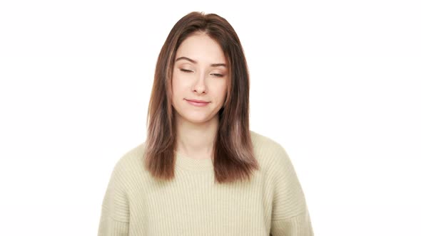 Portrait of Affable Female Model in Casual Dress Looking at Camera Smiling Positively Nodding alt