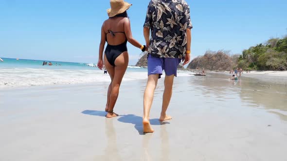 Couple Walking on White Sand Beach in the Caribbean