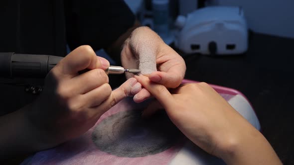 Anonymous Beautician Doing Manicure to Female Client