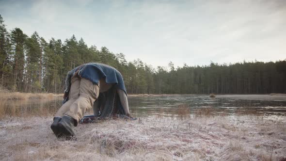 SLIDER shot of an ice bather warming up with qigong before entering the lake alt