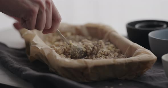 Slow Motion Man Making Granola at Home Mix with Grated Chocolate