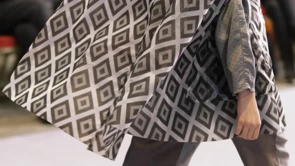 Woman Model in Grey Square Pattern Dress Walks Down Runway alt