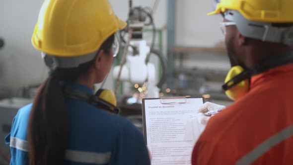 engineer cooperation male and female technician maintenance control relay robot arm alt