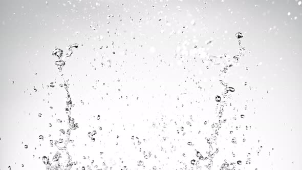 Super Slow Motion Shot of Water Splash on Light Grey Background at 1000Fps alt