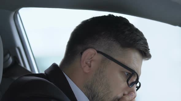 Young Businessman Sneezing in Car, Running Nose Due to Cold, Weak Immune System