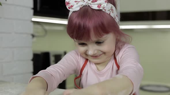 Cooking Pizza. Little Child in Apron Roll Dough with Rolling Pin at Home Kitchen alt