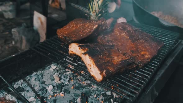 Meat Is Grilled at Street Food Festival. Large Pieces of Pork Roasted on the BBQ alt