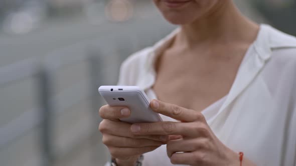 Woman Waiting for Taxi and Using Mobile Phone alt