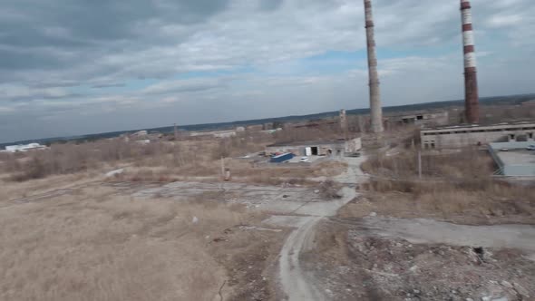 FPV Drone Flies Maneuverable Near Rusty Abandoned Walking Excavator alt