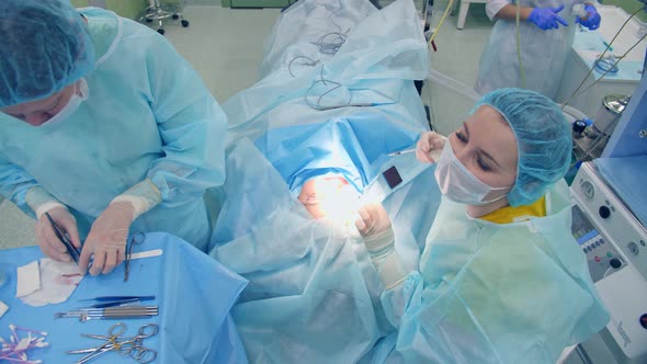 Surgeon Woman Performs Surgery on Patient