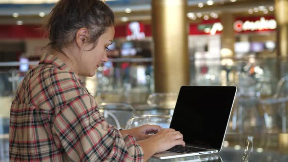 Woman Working with Laptop on Desktop