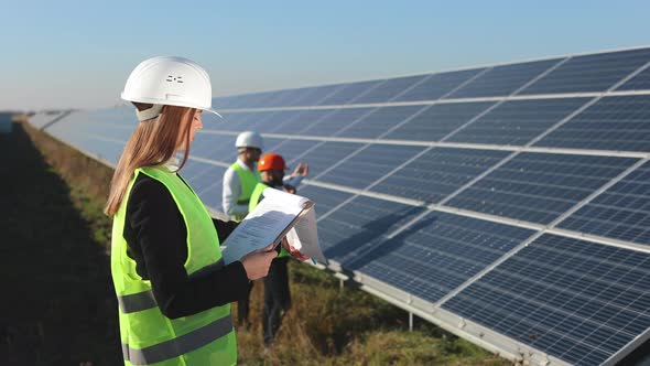 The Female Engineer is Writing the Data to a Document alt