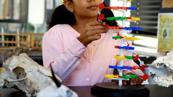 Schoolkid experimenting molecule model in laboratory 4k alt