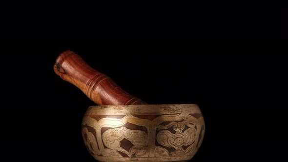 copper singing bowl rotates around its axis