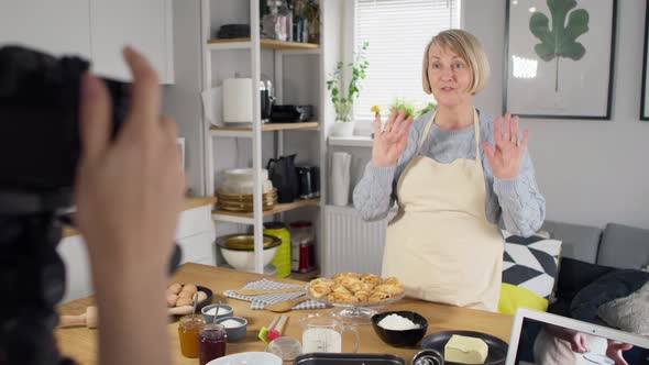 Tracking video of senior woman during filming a video blog.  Shot with RED helium camera in 8K. alt