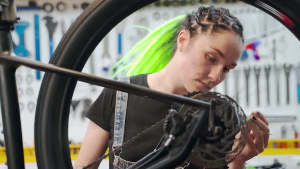 Female Technician Repairing Rotating Bike Wheel