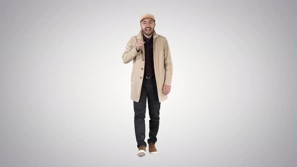 Handsome Man in Light Trench Coat Talking To Camera Focus and Think About It Gestures on Gradient alt