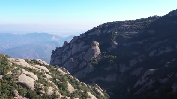 Aerial rising shot of mountain range of Montserrat, Spain