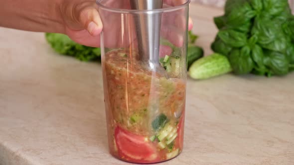 Vegetables are mixed in a blender.