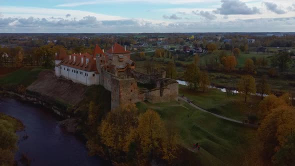 Bauska Medieval Castle Ruins Complex and Park From Above Aerial Shot 4K Video alt