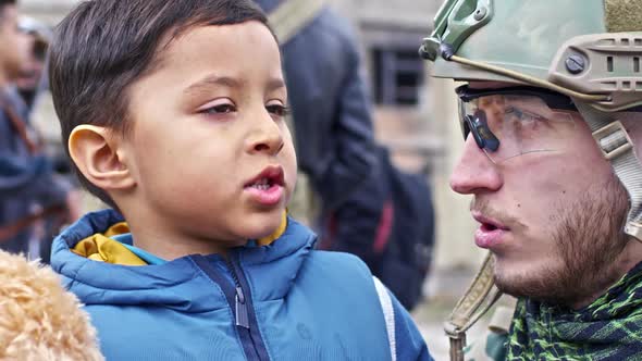 Soldier Talking to Refugee Boy alt