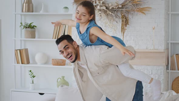 Caring Spaniard Man Loving Father Dad Holds Carries on Back Little Daughter Plays with Girl Child alt