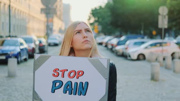 Woman Protesting to Stop Pain By Holding Steamer alt