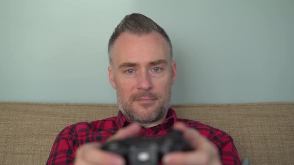 A Man Enjoying Playing a Video Game alt