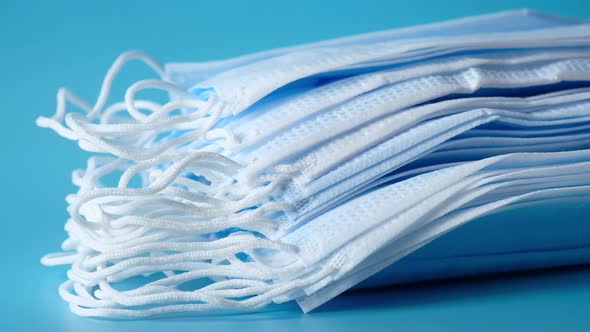 Close Up of Blue Surgical Masks on Table  alt