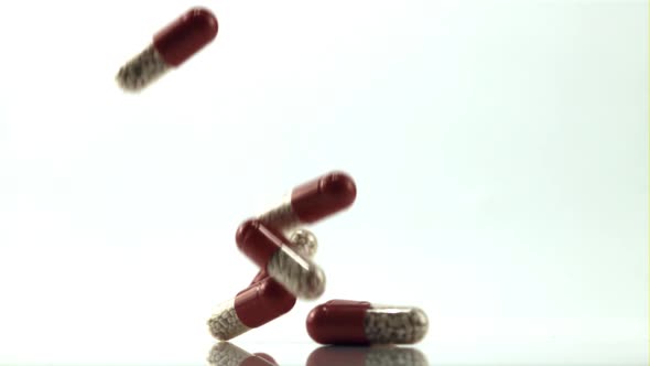 A Bunch of Pills Fall on the Table alt