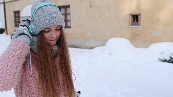 Girl Tourist During Her Vacation Listening To Music Via Headphones and Dancing in Old City Center alt