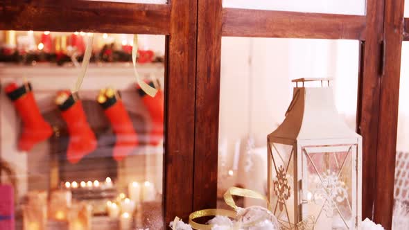 Pine cone and lantern decoration on fake snow alt