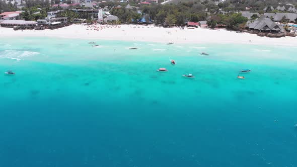 Exotic Sandy Beach with Turquoise Ocean Boats and Hotels Zanzibar Aerial View alt