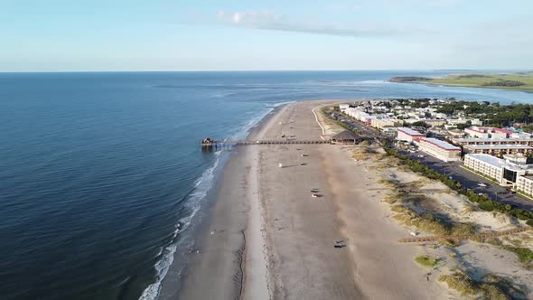 Panama City beach port pier at early morning sunrise, forward aerial alt