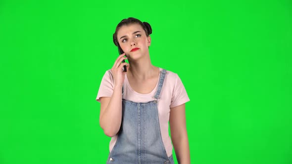 Portrait of Woman Speaking Via Telephone Looking Boredon Green Screen alt