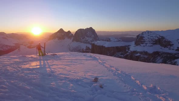 Downhill skier standing on top of mountain, Dolomites, Italy alt