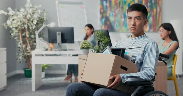 Disabled Sad Men in Shirt with Asian Korean Beauty Sits in Wheelchair at Desk in the Company on alt