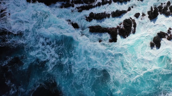 Waves of the Atlantic Ocean crash on coastal rocks alt