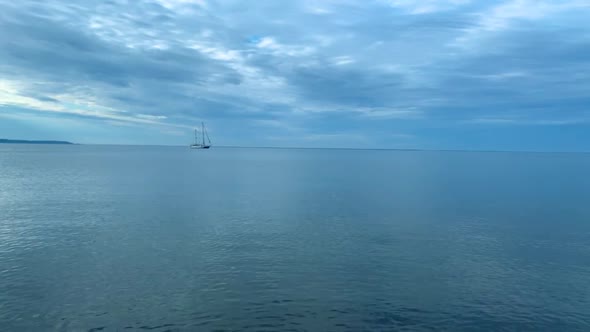 Lonely ship on calm sea, small waves and clear blue water, Baltic Sea in Poland Rewa alt