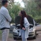 Unsure Young Man and Woman Talking Standing in Forest with Broken Car - VideoHive Item for Sale