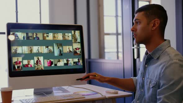 Graphic designers discussing over computer in a modern office 4k alt